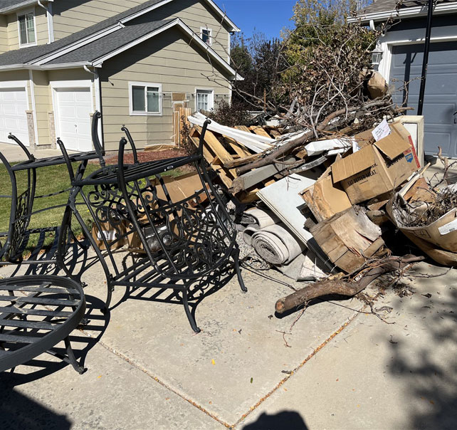 Old patio furniture and junk in a driveway, Frederick junk removal