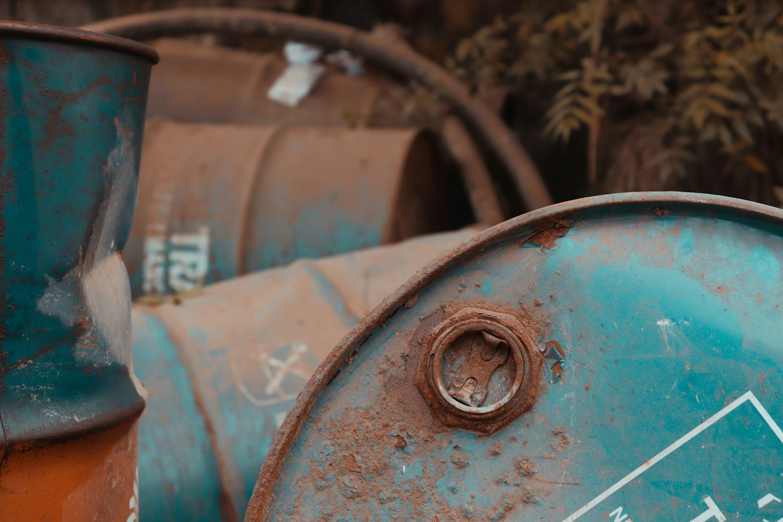 a close up of a blue and orange oil drum, hazardous waste