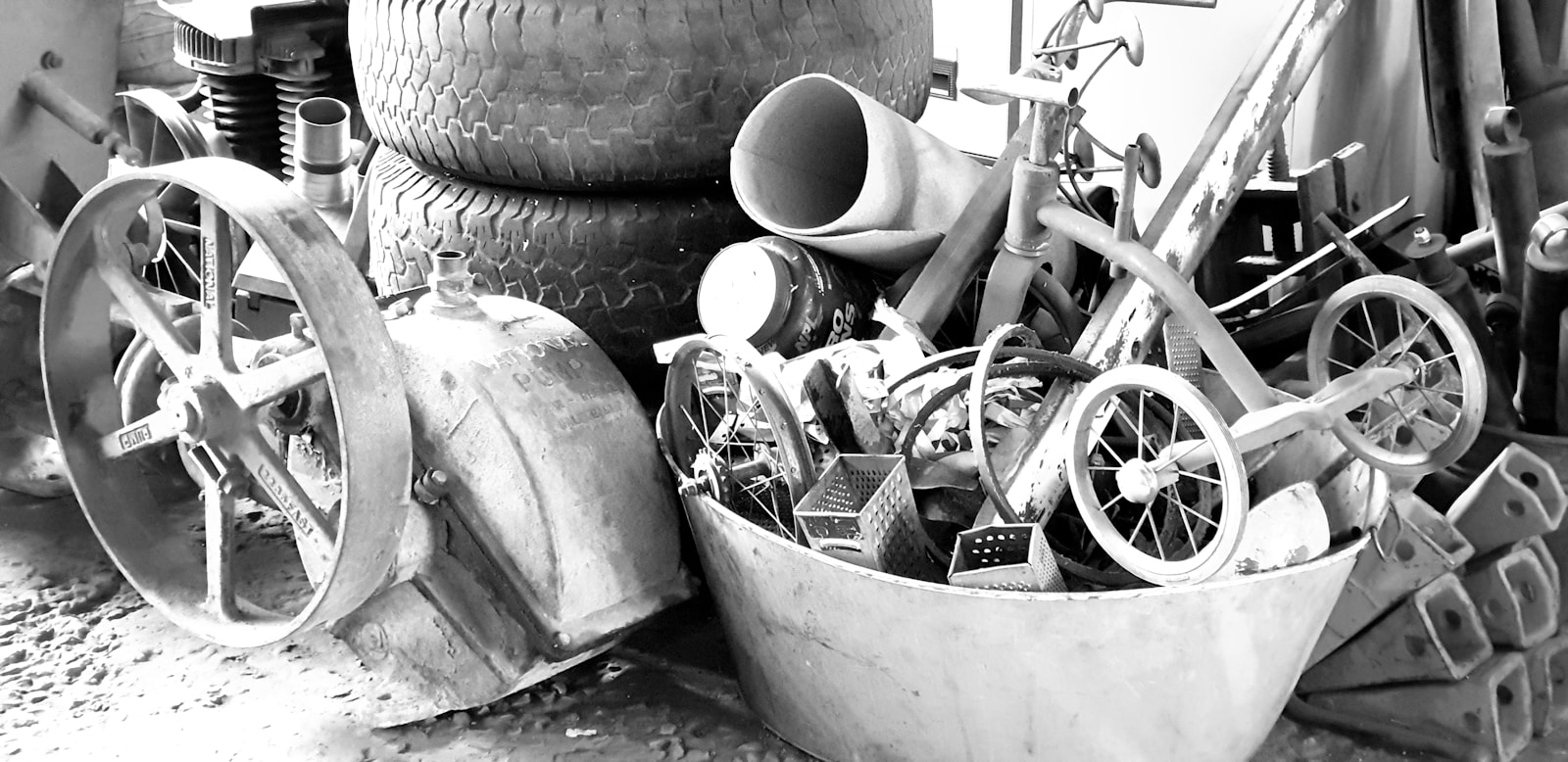 grayscale photo of trike near tires, berthoud junk removal