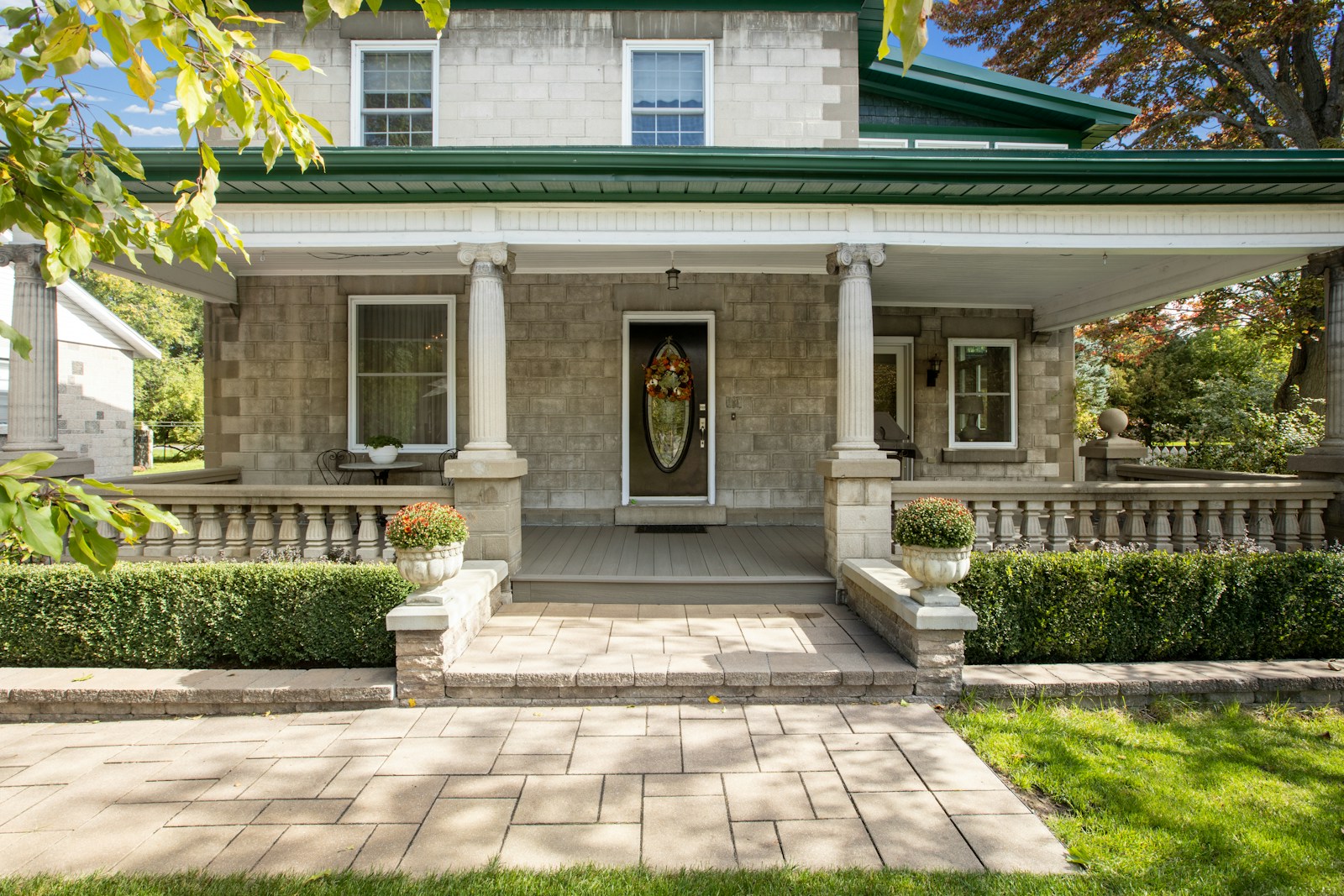 a house with a green roof and white pillars, Firestone Junk Removal